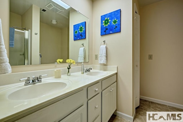 bathroom featuring a shower stall, double vanity, visible vents, and a sink