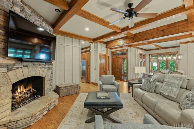 living room with coffered ceiling, light hardwood / wood-style floors, and beam ceiling