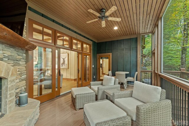 sunroom / solarium featuring wooden ceiling and ceiling fan