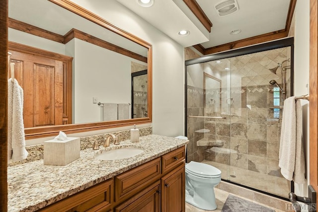 bathroom with toilet, vanity, and a shower with door