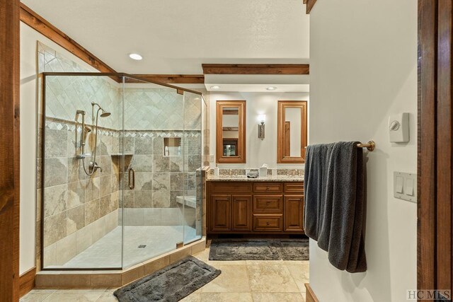 bathroom with walk in shower and vanity