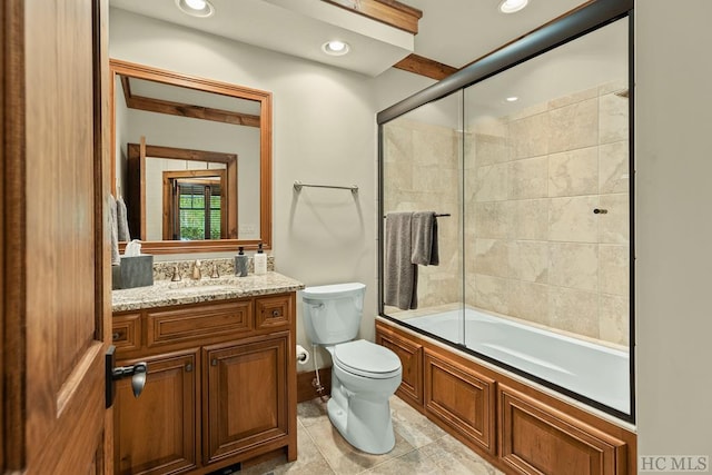 full bathroom featuring bath / shower combo with glass door, vanity, and toilet