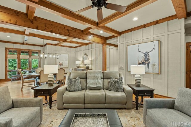 living room with beamed ceiling, ceiling fan, coffered ceiling, and light hardwood / wood-style floors