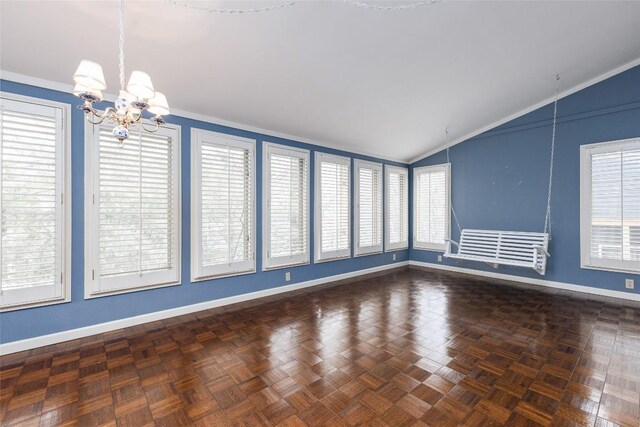 unfurnished living room with a fireplace with flush hearth, wood finished floors, crown molding, lofted ceiling, and a chandelier