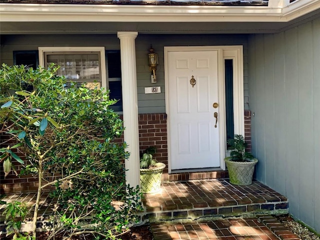 property entrance featuring brick siding