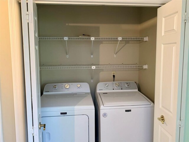 clothes washing area with laundry area and washing machine and clothes dryer