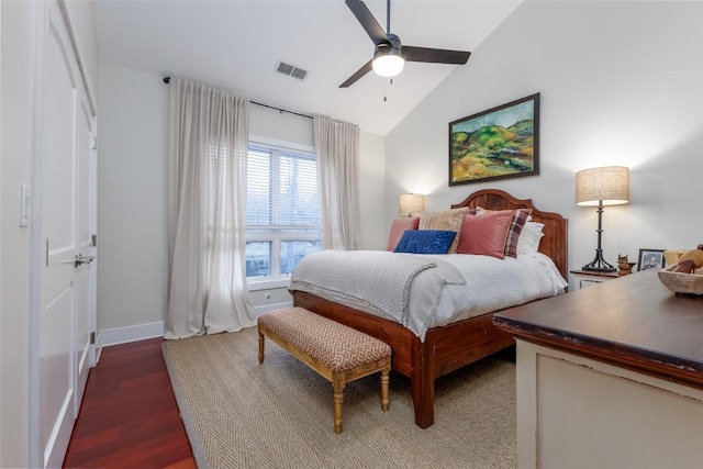 bedroom with lofted ceiling, visible vents, a ceiling fan, wood finished floors, and baseboards