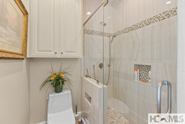 full bath featuring a shower stall and toilet