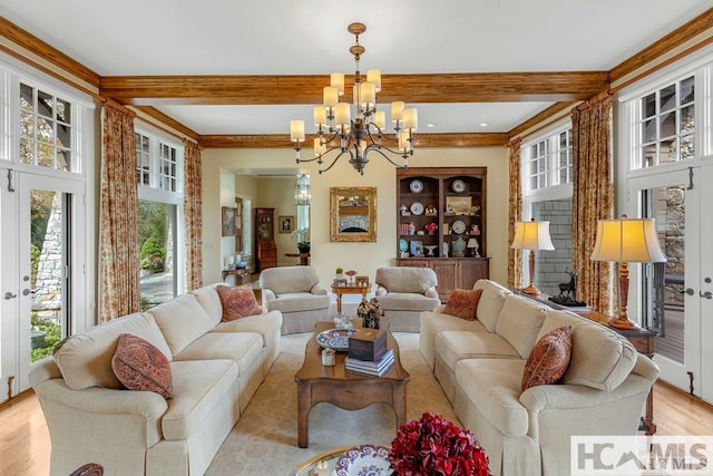 living area featuring a chandelier, beam ceiling, and light wood-type flooring