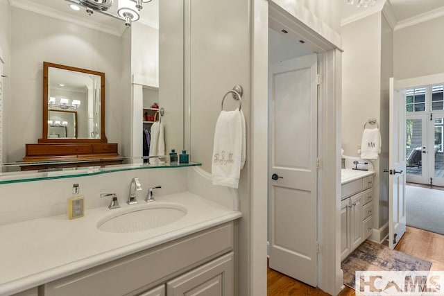 full bathroom with ornamental molding, wood finished floors, and vanity
