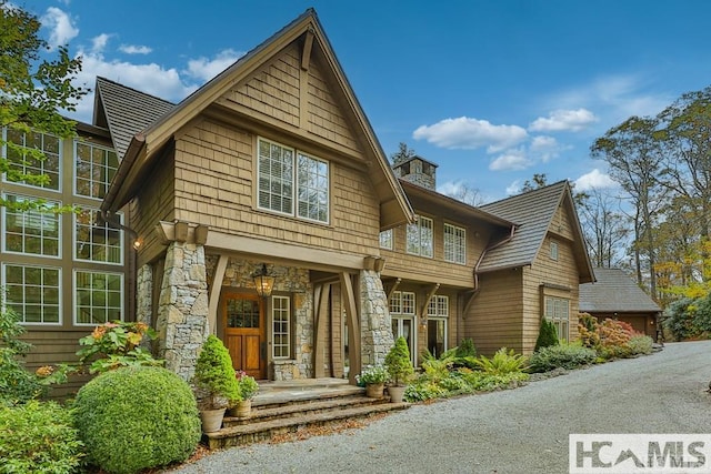 back of property with stone siding
