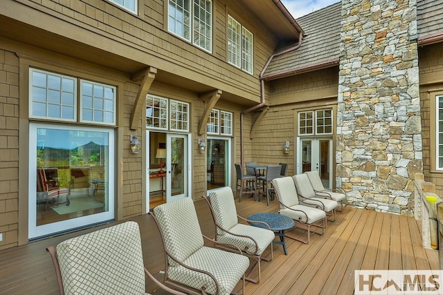 wooden terrace with outdoor dining area