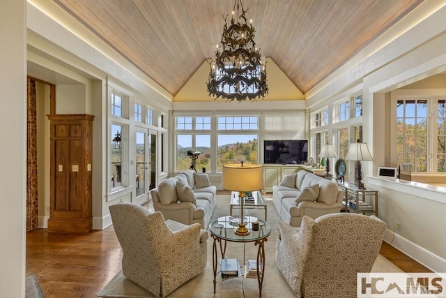 sunroom / solarium with vaulted ceiling and a chandelier