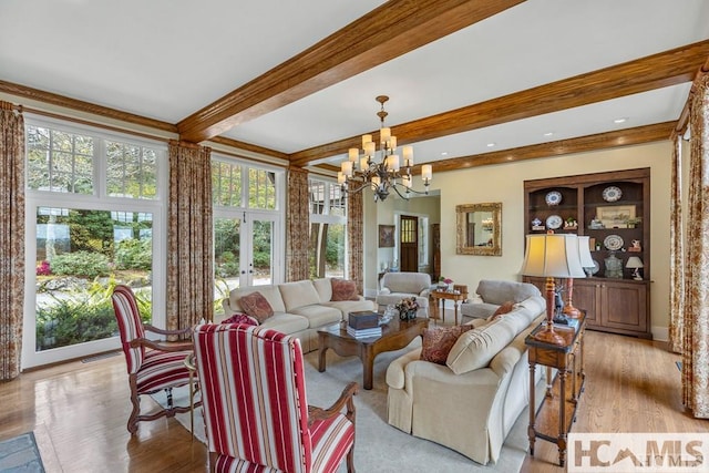 living room with french doors, healthy amount of natural light, a chandelier, beamed ceiling, and light wood-style flooring