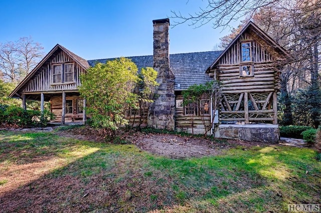 rear view of property featuring a yard