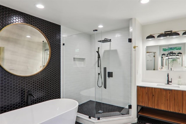 665 Trays Island Rd, Sapphire, NC 28774 - full bath with a stall shower, a soaking tub, vanity, recessed lighting, and tile walls