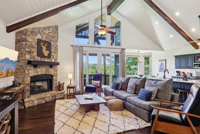 665 Trays Island Rd, Sapphire, NC 28774 - living room featuring a ceiling fan, wood-type flooring, high vaulted ceiling, a stone fireplace, and wooden ceiling with exposed beams