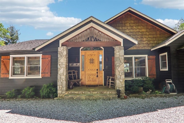 665 Trays Island Rd, Sapphire, NC 28774 - view of front facade featuring a shingled roof, covered porch, and stone siding