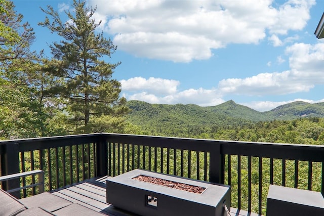 665 Trays Island Rd, Sapphire, NC 28774 - wooden terrace featuring a fire pit, a mountain view, and a forest view