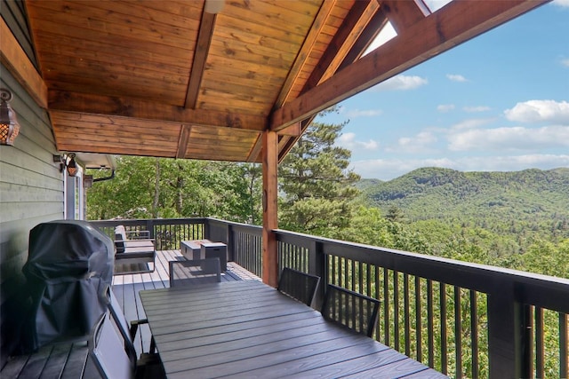 665 Trays Island Rd, Sapphire, NC 28774 - wooden deck featuring a wooded view, outdoor dining space, a mountain view, and a grill
