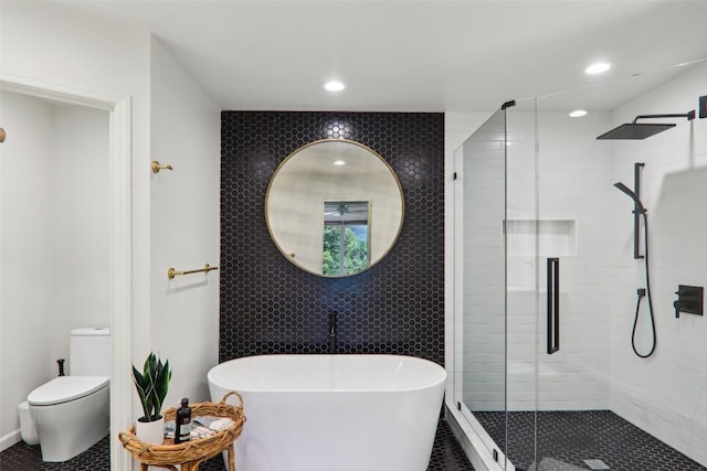 665 Trays Island Rd, Sapphire, NC 28774 - bathroom with a stall shower, a freestanding bath, toilet, recessed lighting, and tile walls
