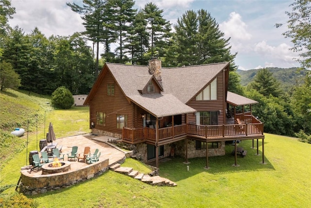 267 Hero Ln, Glenville, NC 28736 - rear view of property featuring an outdoor fire pit, a deck, a yard, and a chimney