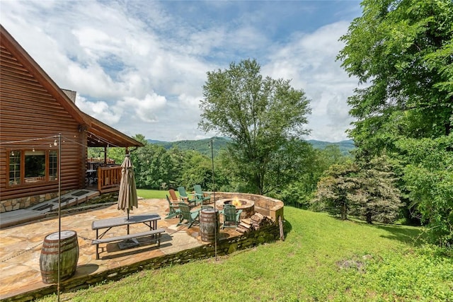 267 Hero Ln, Glenville, NC 28736 - view of grassy yard with an outdoor fire pit, a patio, and a mountain view