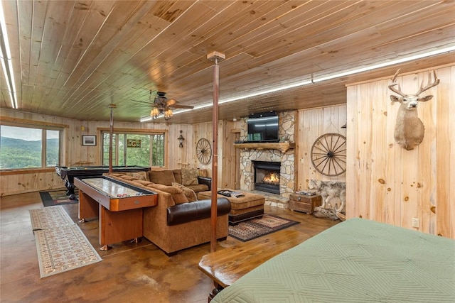 267 Hero Ln, Glenville, NC 28736 - living room featuring pool table, wood ceiling, a fireplace, wood walls, and finished concrete floors