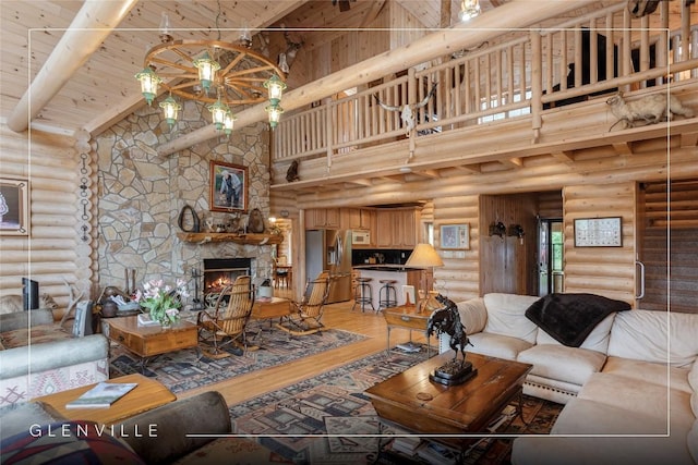 267 Hero Ln, Glenville, NC 28736 - living room featuring high vaulted ceiling, log walls, light wood finished floors, a fireplace, and a wooden ceiling with exposed beams
