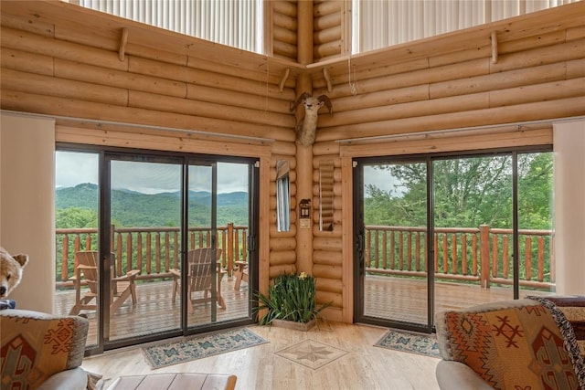 267 Hero Ln, Glenville, NC 28736 - doorway to outside featuring a towering ceiling, hardwood / wood-style flooring, log walls, and healthy amount of natural light