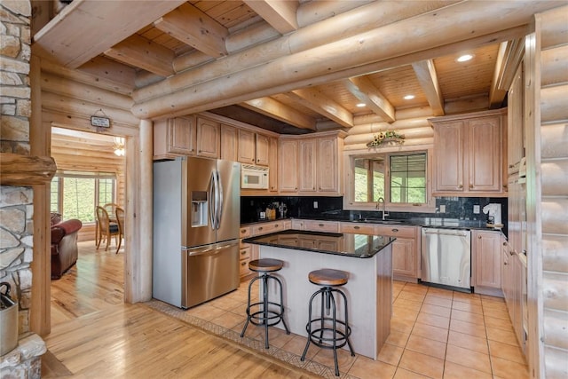 267 Hero Ln, Glenville, NC 28736 - kitchen featuring stainless steel appliances, a wood ceiling with exposed beams, rustic walls, dark countertops, and tasteful backsplash
