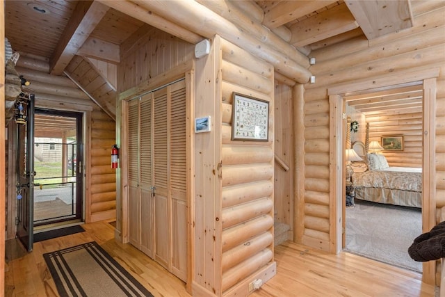 267 Hero Ln, Glenville, NC 28736 - hallway featuring rustic walls, light wood-type flooring, and a wood ceiling with exposed beams