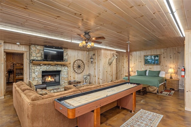 267 Hero Ln, Glenville, NC 28736 - recreation room featuring wooden ceiling, ceiling fan, wooden walls, a stone fireplace, and concrete flooring