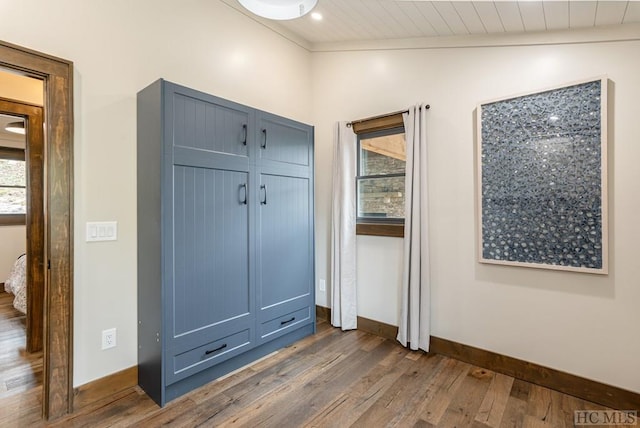 mudroom with dark hardwood / wood-style flooring and vaulted ceiling