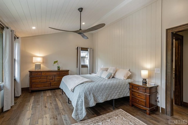 bedroom with dark hardwood / wood-style flooring and ceiling fan