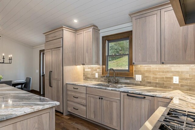 kitchen with light stone counters, sink, and light brown cabinets