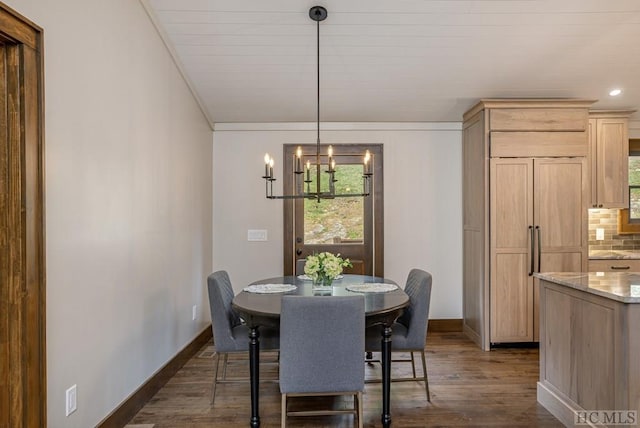 dining room with crown molding, a healthy amount of sunlight, and dark wood-type flooring