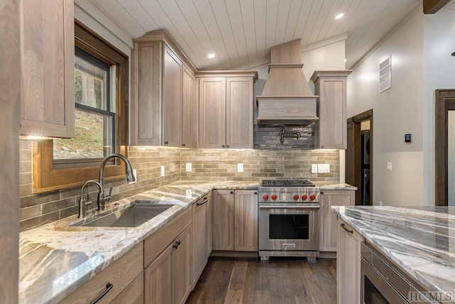 kitchen featuring vaulted ceiling, sink, dark hardwood / wood-style flooring, stainless steel appliances, and light brown cabinets