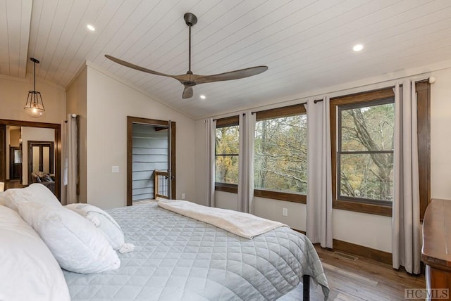 bedroom featuring wood-type flooring, vaulted ceiling, wooden ceiling, and ceiling fan