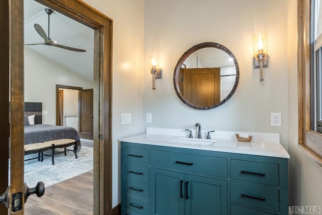 bathroom featuring hardwood / wood-style flooring, ceiling fan, lofted ceiling, and vanity