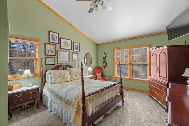 carpeted bedroom with ornamental molding, lofted ceiling, and ceiling fan