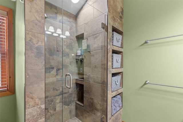 bathroom featuring a shower with shower door