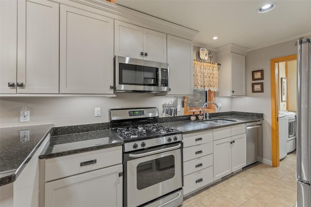 kitchen featuring white cabinetry, stainless steel appliances, sink, light tile patterned floors, and crown molding