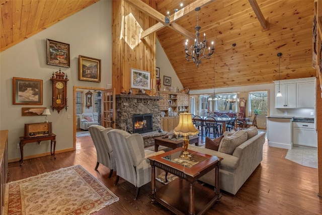 living room featuring hardwood / wood-style flooring, a chandelier, a stone fireplace, and wood ceiling