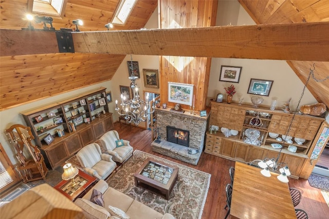 living room with a fireplace, high vaulted ceiling, wood-type flooring, and a skylight