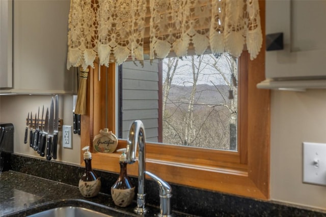 room details featuring sink and stone countertops