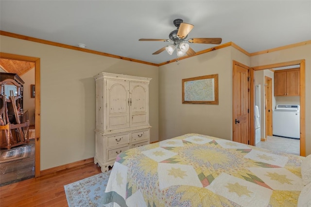 bedroom featuring ceiling fan, light wood-type flooring, crown molding, and washer / dryer