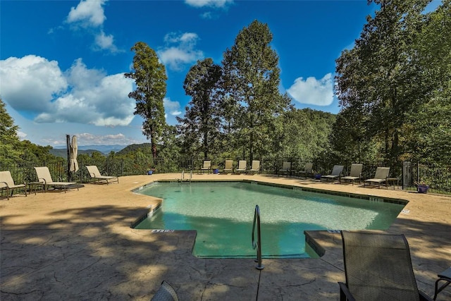 view of pool with a patio area and a mountain view