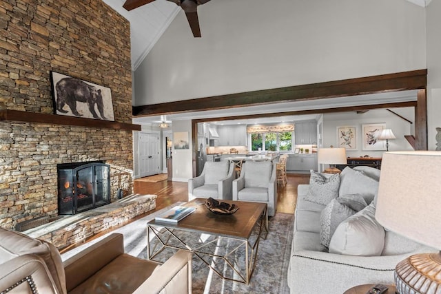 108 W View Way, Highlands, NC 28741 - living area with high vaulted ceiling, wood finished floors, a ceiling fan, a stone fireplace, and beam ceiling
