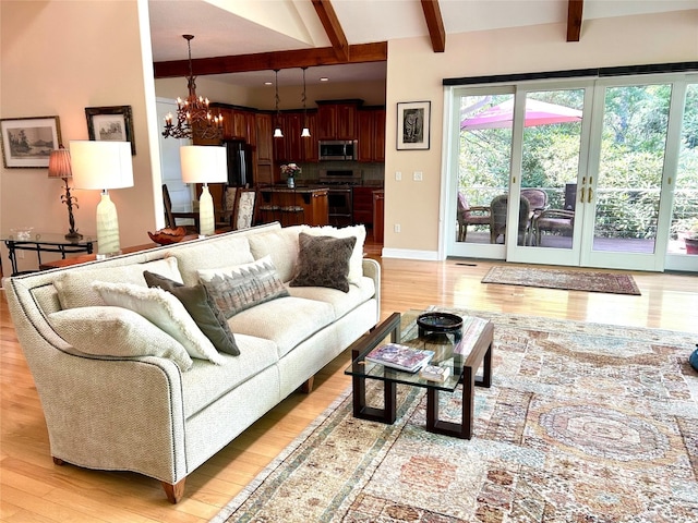 135 Whisper Lake Dr, Sapphire, NC 28774 - living room with beamed ceiling, a chandelier, light wood finished floors, and healthy amount of natural light